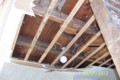 Ceiling and Rafters. With the modern gyproc ceiling removed, the original rafters may be seen – as well as the second story floor boards.